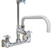 A T&S chrome wall mounted hose reel faucet with 4-arm handles.