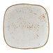 A white square Tuxton China plate with brown specks.