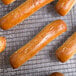 A rack of Dutch Country Foods soft pretzel sticks with sesame seeds on top.