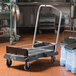 A black Rubbermaid Ice Tote cart with wheels.