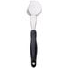 A Vollrath Jacob's Pride 3-sided solid basting spoon with a black Ergo Grip handle.