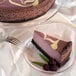 A slice of Pellman raspberry cheesecake with a purple and white swirl on a plate with a fork.