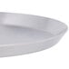 An American Metalcraft heavy weight aluminum pizza pan with a close-up of the silver metal.