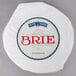 A round white package of Imported Soft Ripened Brie Cheese with a blue and red logo.