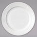 A white Arcoroc porcelain bread and butter plate with a wavy design.