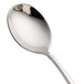 A Oneida silver spoon with a curved handle.