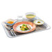 An Arcoroc stackable square bowl filled with food on a tray.