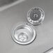 A close-up of a Regency stainless steel multi-station sink with a silver drain.