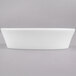 A close up of a white rectangular Arcoroc porcelain baker on a white surface.