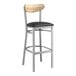 A Lancaster Table & Seating bar stool with a black vinyl seat and driftwood back.