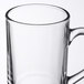 An Arcoroc clear tempered glass mug with a handle.