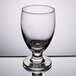A close-up of a Libbey Banquet Goblet on a reflective surface.