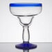 A clear glass with a blue rim and base.