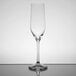 A Stolzle Grand Cuvée flute wine glass on a reflective surface.