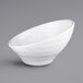 A close-up of a white Elite Global Solutions Durango melamine bowl with a curved edge.