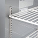 A close-up of a white metal shelf in a Beverage-Air worktop refrigerator.