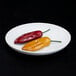An off white Elite Global Solutions deep oval melamine plate with two chili peppers.