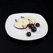 An Elite Global Solutions off white square melamine plate with fruit on it.