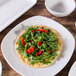 An Elite Global Solutions Tenaya off white square melamine plate with a flatbread topped with greens on it.