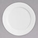 A white Chef & Sommelier bone china dinner plate with a white rim.