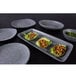 A set of Elite Global Solutions granite stone melamine plates with food on a table.