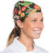 A woman wearing a vegetable patterned chef bandana.