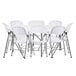 A Lancaster Table & Seating white plastic folding table with white folding chairs stacked on top.