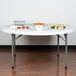 A Lancaster Table & Seating folding table with food on it.