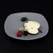 An Elite Global Solutions granite stone square melamine plate with fruit and berries.