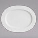 A white Chef & Sommelier bone china oval platter on a gray surface.