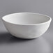 An Elite Global Solutions Tenaya off white melamine bowl on a gray surface.
