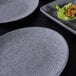 An Elite Global Solutions Tenaya granite stone melamine plate with food on it.