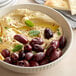 A bowl of hummus with Kalamata olives.