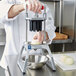 A chef using a Vollrath Redco InstaCut 3.5 wedger to cut onions.
