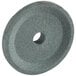 An Avantco fine sharpening stone with a hole in the center on a grey surface.