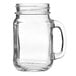An Arcoroc clear glass jar with a handle.
