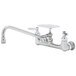 A silver T&S wall mount pantry faucet with soap dish.