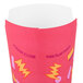A pink Solo paper container with yellow and orange graphic designs.