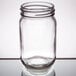 An Arcoroc clear glass Mason jar with a lid on a table.