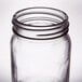 An Arcoroc clear glass Mason jar with a lid.
