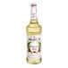 A bottle of Monin Premium Pure Cane Syrup with a white label.
