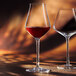 Two Chef & Sommelier Reveal' Up wine glasses filled with red wine.