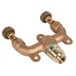 A T&S Brass wall mounted mixing valve assembly with two brass nuts on a metal pipe.