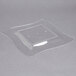 A clear plastic square plate with a white background.