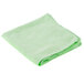 A folded green Rubbermaid microfiber cloth on a white background.