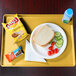 A Cambro Tuscan Gold dietary tray with a sandwich, vegetables, and a bottle of water.