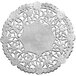 A close-up of a 4" silver foil lace doily with flowers on it.