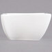 An American Metalcraft white porcelain wave bowl with a square shape on a white surface.