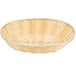 A Thunder Group natural-colored oval rattan basket with a white background.