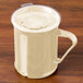 A beige Cambro polycarbonate mug with a handle on a wooden table.